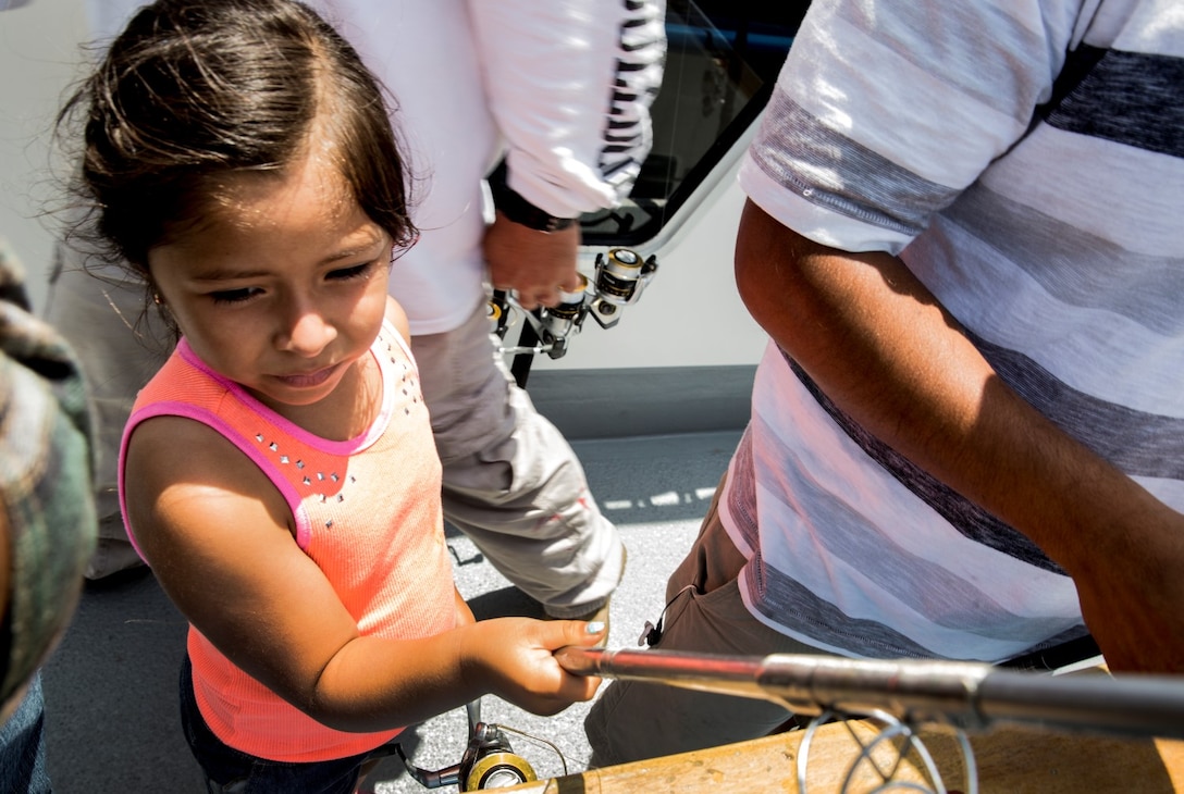 Aubry, 6, reels in a catch during a youth fishing trip aboard the fishing vessel Dana Pride off the coast of Southern California, June 26, 2014. More than 30 service members and children participated in the event. (U.S. Marine Corps photo by Cpl. Emmanuel Ramos/Released)