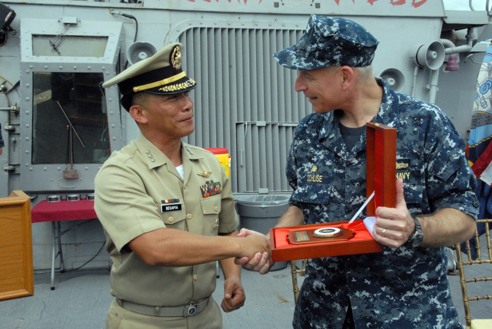 SUBIC BAY, Philippines (July 1, 2014) - Capt. Paul Schlise, commodore of Destroyer Squadron 7, accepts an award of appreciation from Capt. Karl A. Decapia of the Philippine Navy at the closing ceremony of Cooperation Afloat Readiness and Training (CARAT) 2014. In its 20th year, CARAT is an annual, bilateral exercise series with the U.S. Navy, U.S. Marine Corps and the armed forces of nine partner nations including Bangladesh, Brunei, Cambodia, Indonesia, Malaysia, the Philippines, Singapore, Thailand and Timor-Leste. (U.S. Navy photo by Mass Communication Specialist 1st Class Jerry Jimenez) 140701-N-PK322-086