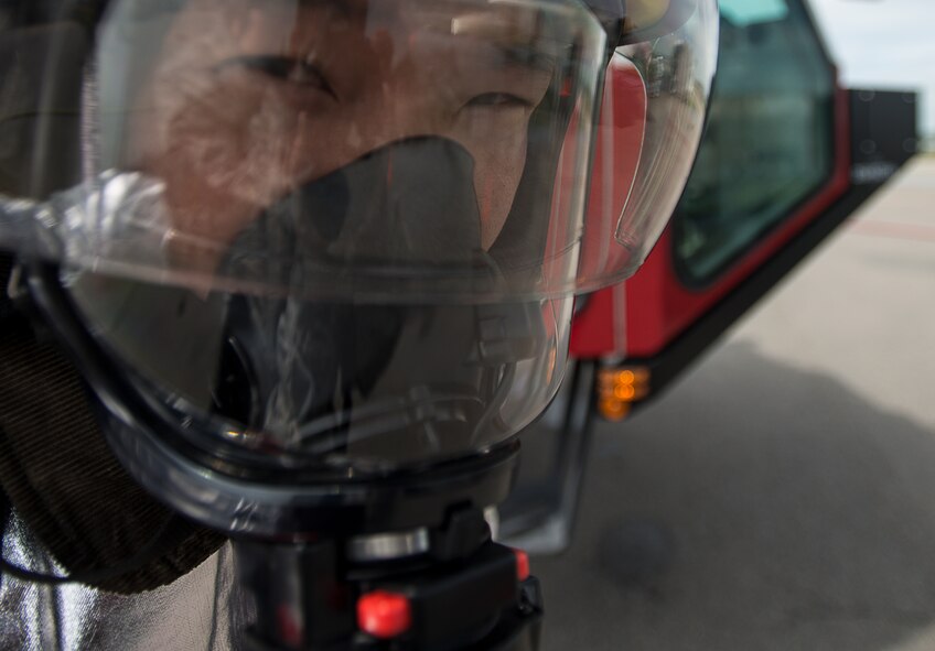 A firefighter catches their breath after extinguishing during a live fire training exercise April 29, 2014, at Osan Air Base, Republic of Korea. The training tested U.S. and RoK firefighters on their ability to respond to a variety of situations. (U.S. Air Force photo by Staff Sgt. Jake Barreiro)
