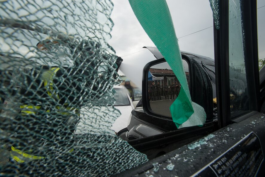 A South Korean firefighter sprays water on a fire during a training exercise April 29, 2014, at Osan Ari Base, Republic of Korea. The training consisted of extinguishing a live fire in a vehicle and rescuing simulated victims in the form of dummys. (U.S. Air Force photo by Staff Sgt. Jake Barreiro)