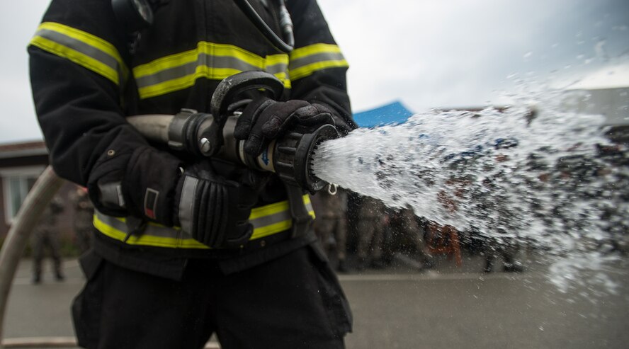 Firefighters from the United States and South Korean Air Forces train together April 29, 2014, at Osan Air Base, Republic of Korea. The training tested the international services abilities to work together in emergency environments. (U.S. Air Force photo by Staff Sgt. Jake Barreiro)