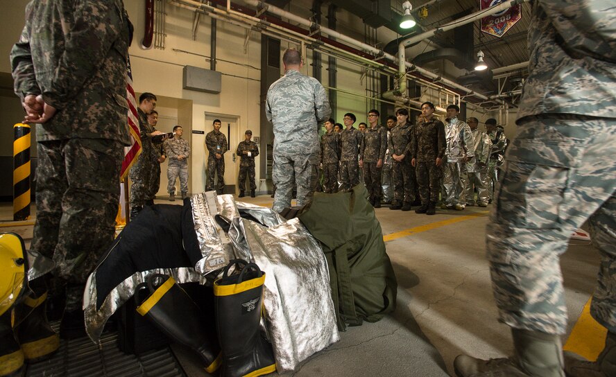Firefighters with the South Korean Air Force receive a briefing April 29, 2014, at Osan Air Base, Republic of Korea. Korea and U.S. firefighters participate in joint training to better enhance the traditional and emergency services they provide their respective areas of responsiblity. (U.S. Air Force photo by Staff Sgt. Jake Barreiro)