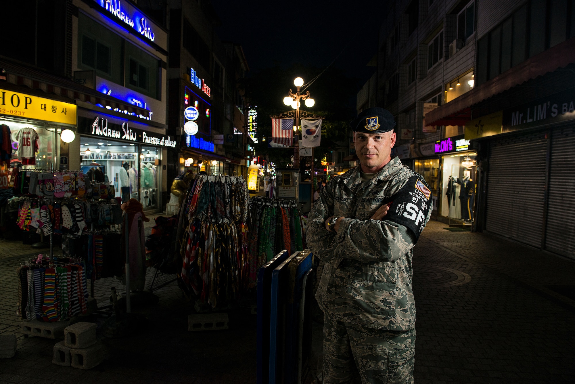 Tech. Sgt. Jason Winkle, 51st Security Forces Squadron town patrol NCO in charge, stands in the Songtan Entertainment District outside Osan Air Base, Republic of Korea, June 27, 2014. Members of town patrol prowl the streets of the SED during the hours of darkness to ensure the safety of service members and the general public. (U.S. Air Force photo/Staff Sgt. Jake Barreiro)