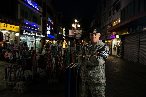 Tech. Sgt. Jason Winkle, 51st Security Forces Squadron town patrol NCO in charge, stands in the Songtan Entertainment District outside Osan Air Base, Republic of Korea, June 27, 2014. Members of town patrol prowl the streets of the SED during the hours of darkness to ensure the safety of service members and the general public. (U.S. Air Force photo/Staff Sgt. Jake Barreiro)