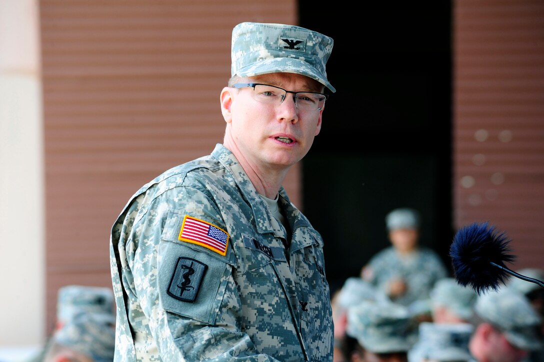 U. S. Army Col. David Wolken, the new Medical Element (MEDEL) commander, speaks to the more than 100 Joint Task Force-Bravo Airmen, Soldiers, and Sailors which included other commanders from Joint Task Force-Bravo mission support commands and representatives from the Honduras armed forces and local hospital dignitaries, during MEDEL's change of command ceremony at Soto Cano Air Base, Honduras, June 30, 2014. Wolken assumed command from U. S. Army Lt. Col. Huy Luu.  Joint Task Force-Bravo's MEDEL is composed of 64 Army personnel who have come together from across the United States and have provided medical care to more than 8,000 people in Honduras over the last 12 months. MEDEL provides preventative medical care, wellness check-ups, dental care, preventative dental care, surgical care, and physical therapy through local partnerships in Comayagua, Tegucigalpa, and through local Medical Readiness Training Exercises (MEDRETES) which are carried out on a weekly basis.  MEDEL hosts many training opportunities with the country of Honduras to build strong partnerships between both countries.  (Photo by Martin Chahin)