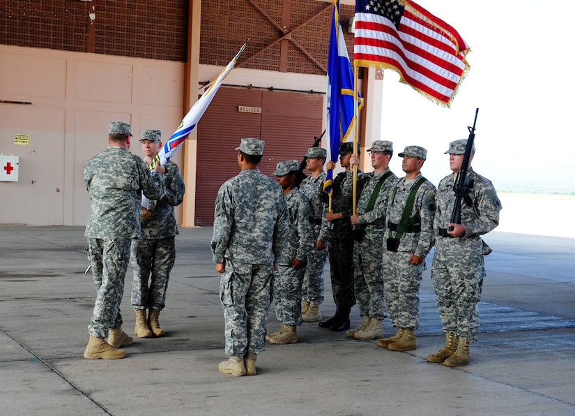 U. S. Army Col. David Wolken assumes command of Joint Task Force- Bravo Medical Element, at Soto Cano Air Base, Honduras by accepting the guidon from U. S. Army Col. Kirk Dorr, the Joint Task Force-Bravo commander, June 30, 2014. Wolken assumed command from U. S. Army Lt. Col. Huy Luu.  Joint Task Force-Bravo's MEDEL is composed of 64 Army personnel who have come together from across the United States and have provided medical care to more than 8,000 people in Honduras over the last 12 months. MEDEL provides preventative medical care, wellness check-ups, dental care, preventative dental care, surgical care, and physical therapy through local partnerships in Comayagua, Tegucigalpa, and through local Medical Readiness Training Exercises (MEDRETES) which are carried out on a weekly basis.  MEDEL hosts many training opportunities with the country of Honduras to build strong partnerships between both countries.  (Photo by Martin Chahin)