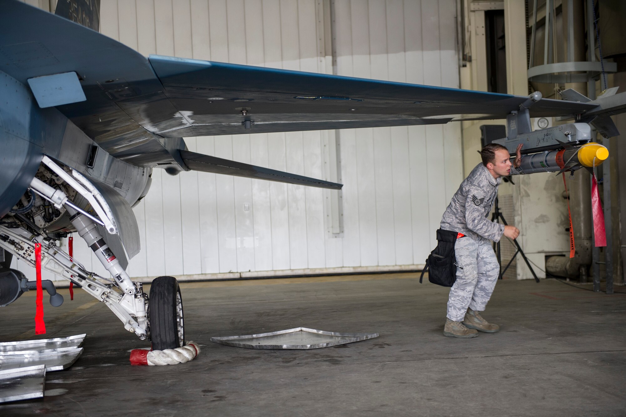 U.S. Air Force Staff Sgt. Jason Macklin, 354th Aircraft Maintenance Squadron armament systems technician, performs final inspections on an F-16 Fighting Falcon during a load crew competition June 30, 2014, Eielson Air Force Base, Alaska. Macklin led his crew in the competition that highlighted Eielson’s top performing load crews of the second quarter. (U.S. Air Force photo by Senior Airman Joshua Turner/Released)