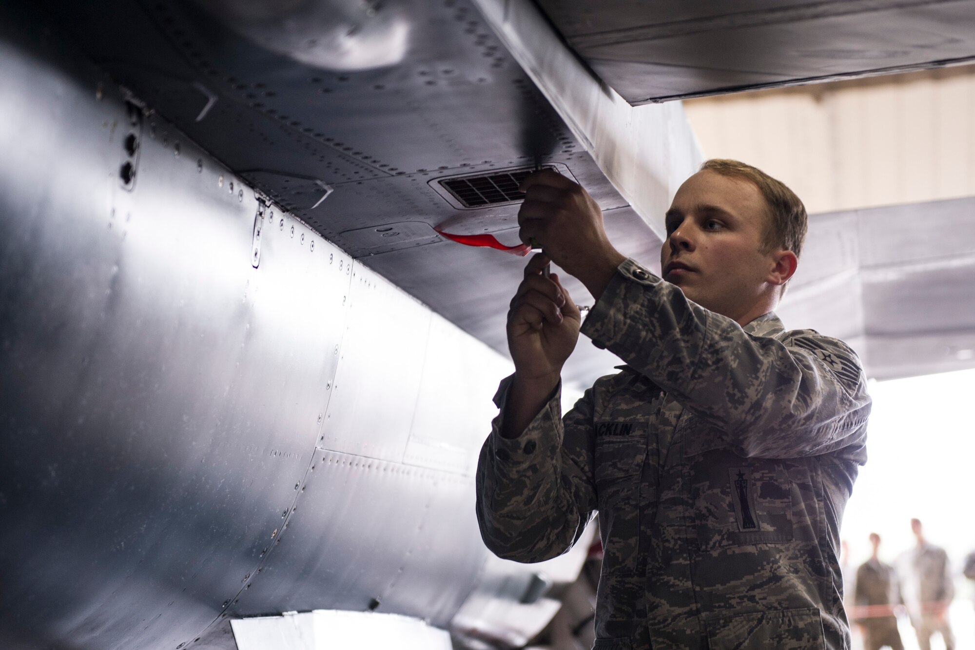 U.S. Air Force Staff Sgt. Jason Macklin, 354th Aircraft Maintenance Squadron armament systems technician, secures a battery on an F-16 Fighting Falcon during a load crew competition June 30, 2014, Eielson Air Force Base, Alaska. Macklin led his crew in the competition that highlighted Eielson’s top performing load crews of the second quarter. (U.S. Air Force photo by Senior Airman Joshua Turner/Released)