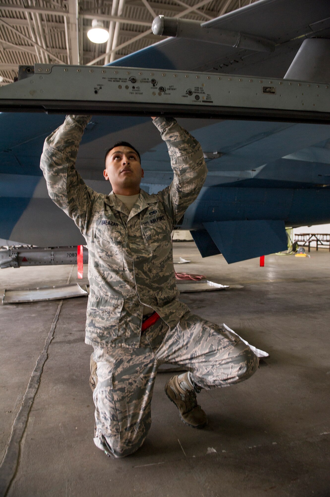 U.S. Air Force Senior Airman Zachary Salazar, 354th Maintenance Squadron armament technician, prepares an F-16 Fighting Falcon missile launcher during a load crew competition June 30, 2014, Eielson Air Force Base, Alaska. The competition highlighted Eielson’s top load crews in recognition for their outstanding performance and safety record throughout the quarter. (U.S. Air Force photo by Senior Airman Joshua Turner/Released)
