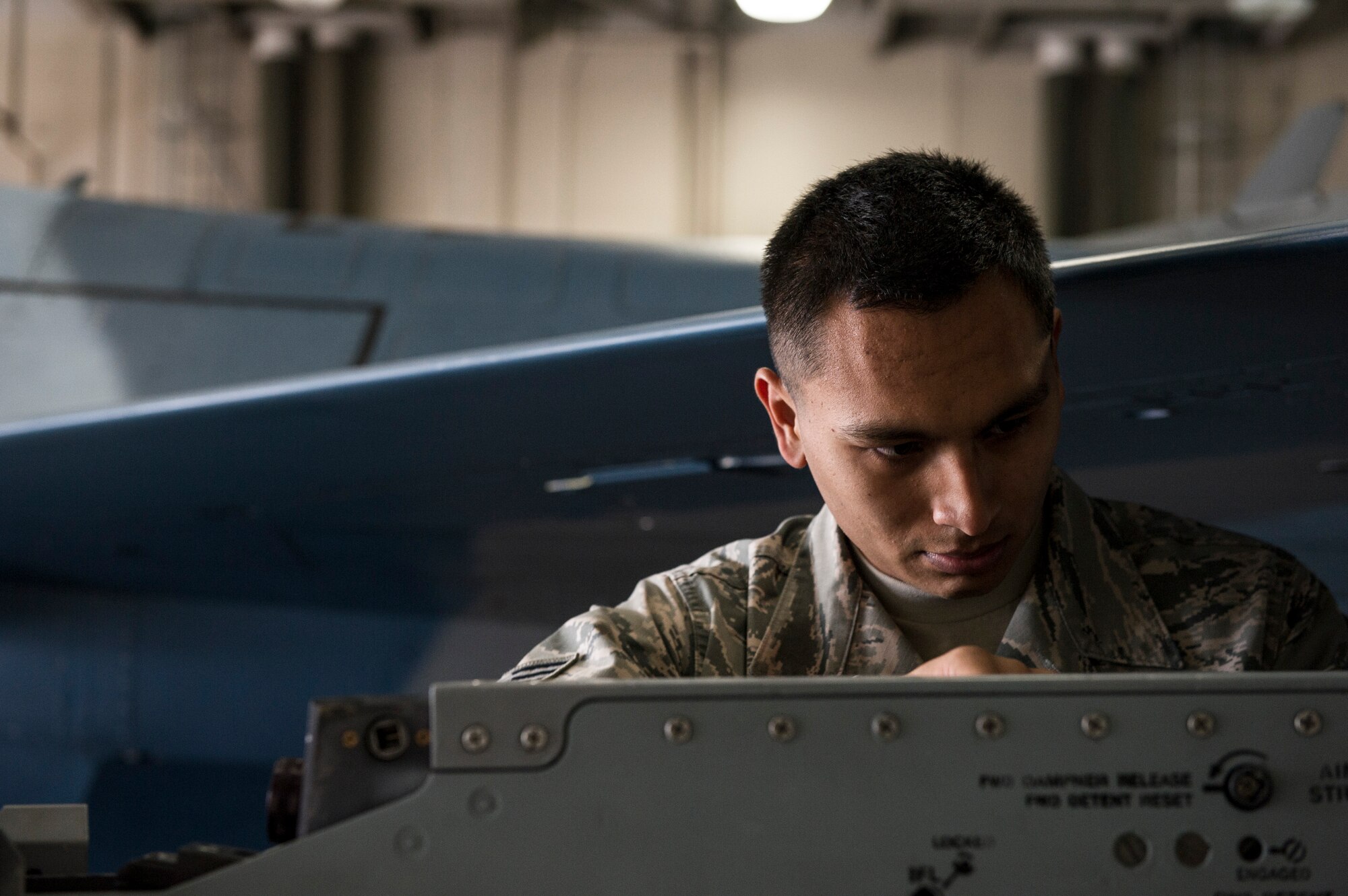 U.S. Air Force Senior Airman Zachary Salazar, 354th Aircraft Maintenance Squadron armament technician, prepares an F-16 Fighting Falcon during a load crew competition June 30, 2014, Eielson Air Force Base, Alaska. Points are awarded during the weapons loading, tool kit inspection and uniform inspection for the competition. (U.S. Air Force photo by Senior Airman Joshua Turner/Released)
