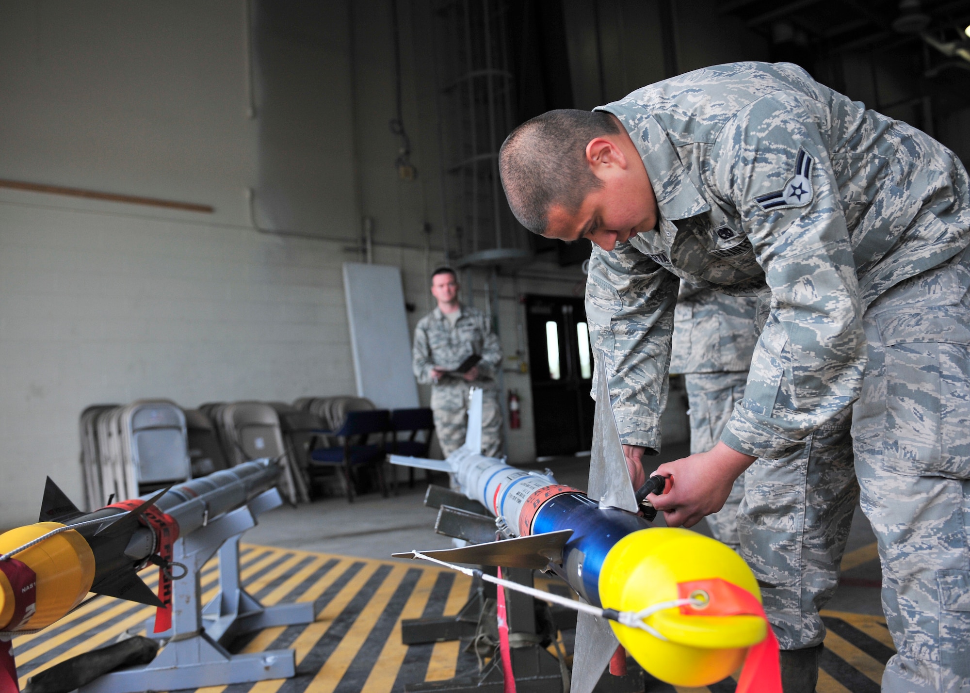 Airman 1st Class Uziel Huerta, 354th Aircraft Maintenance Squadron weapons load crew member, prepares an AIM-9 Sidewinder missile to load onto an F-16 Fighting Falcon during a load crew competition June 30, 2014, Eielson Air Force Base, Alaska. Huerta and other load crew members inspected and readied the aircraft before a timed weapons loading event. (U.S. Air Force photo by Senior Airman Ashley Nicole Taylor/Released)