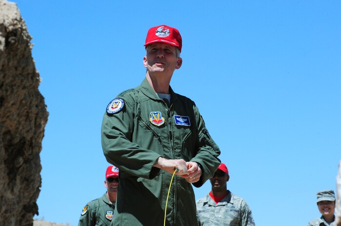 Gen. Mike Hostage, commander of Air Combat Command, detonates 250 lbs. of explosives rigged by Airmen assigned to the 820th RED HORSE at the Area 11 rock quarry June 27, 2014, at Nellis Air Force Base, Nev. As part of their mission, RED HORSE Airmen train in various skills that enable the unit to remain self- sufficient in even the most austere environments. (U.S. Air Force photo by Airman 1st Class Joshua Kleinholz/released)