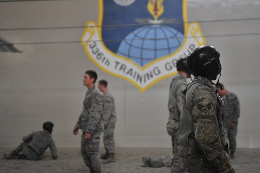 Students attending the Survival, Evasion, Resistance and Escape school listen to their instructors about parachute landing safety at Fairchild Air Force Base, Washington, June 27, 2014.  The 22nd Training Squadron parachute training tests, evaluates, demonstrates, and instructs emergency egress parachute systems for Air Force aircrew career fields. (U.S. Air Force photo by Staff Sgt. Alexandre Montes/Released)