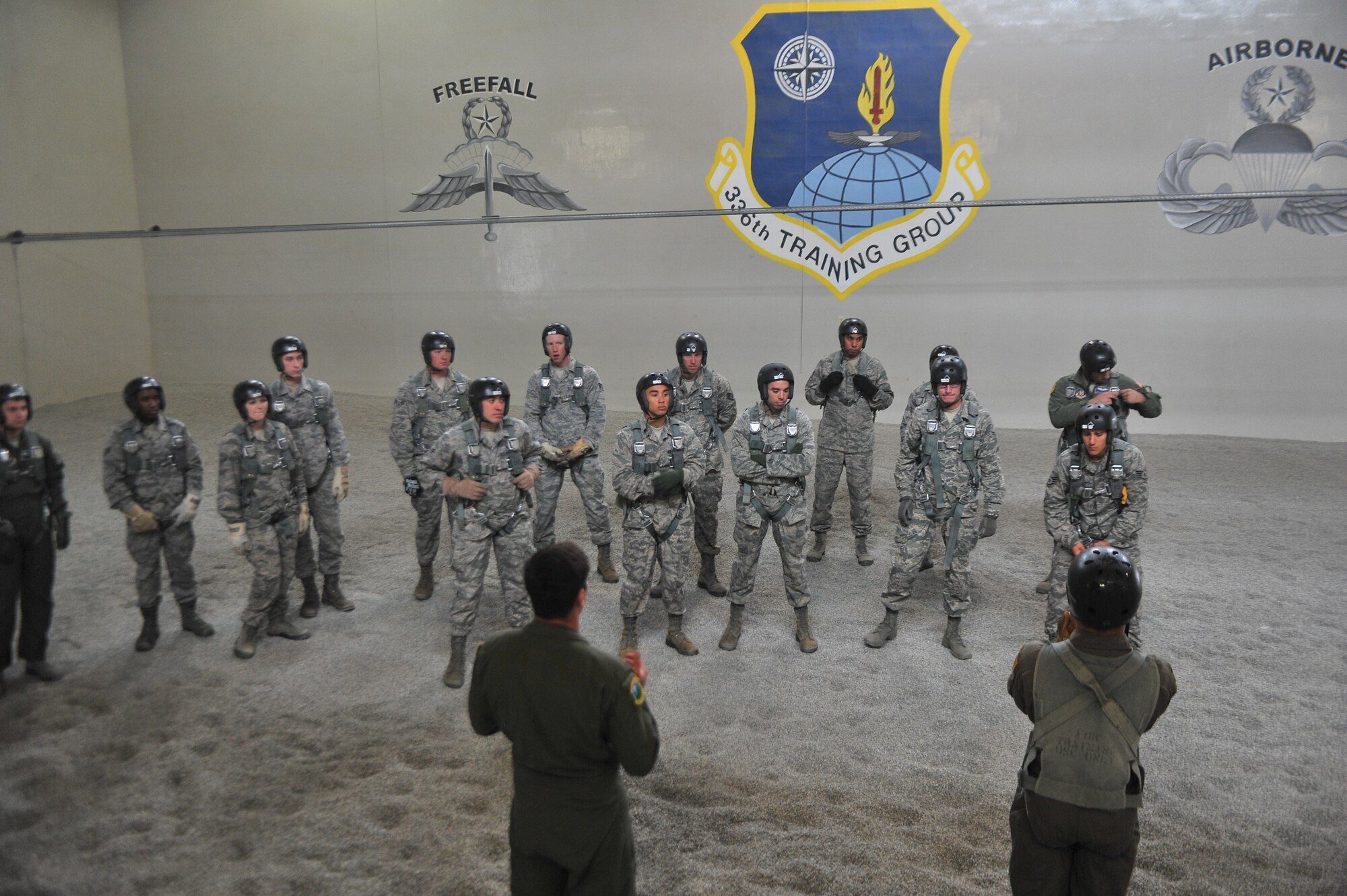 Students attending the Survival, Evasion, Resistance and Escape school listen to their instructors about parachute landing safety at Fairchild Air Force Base, Washington, June 27, 2014.  The 22nd Training Squadron parachute training tests, evaluates, demonstrates and instructs emergency egress parachute systems for Air Force aircrew career fields. (U.S. Air Force photo by Staff Sgt. Alexandre Montes/Released)