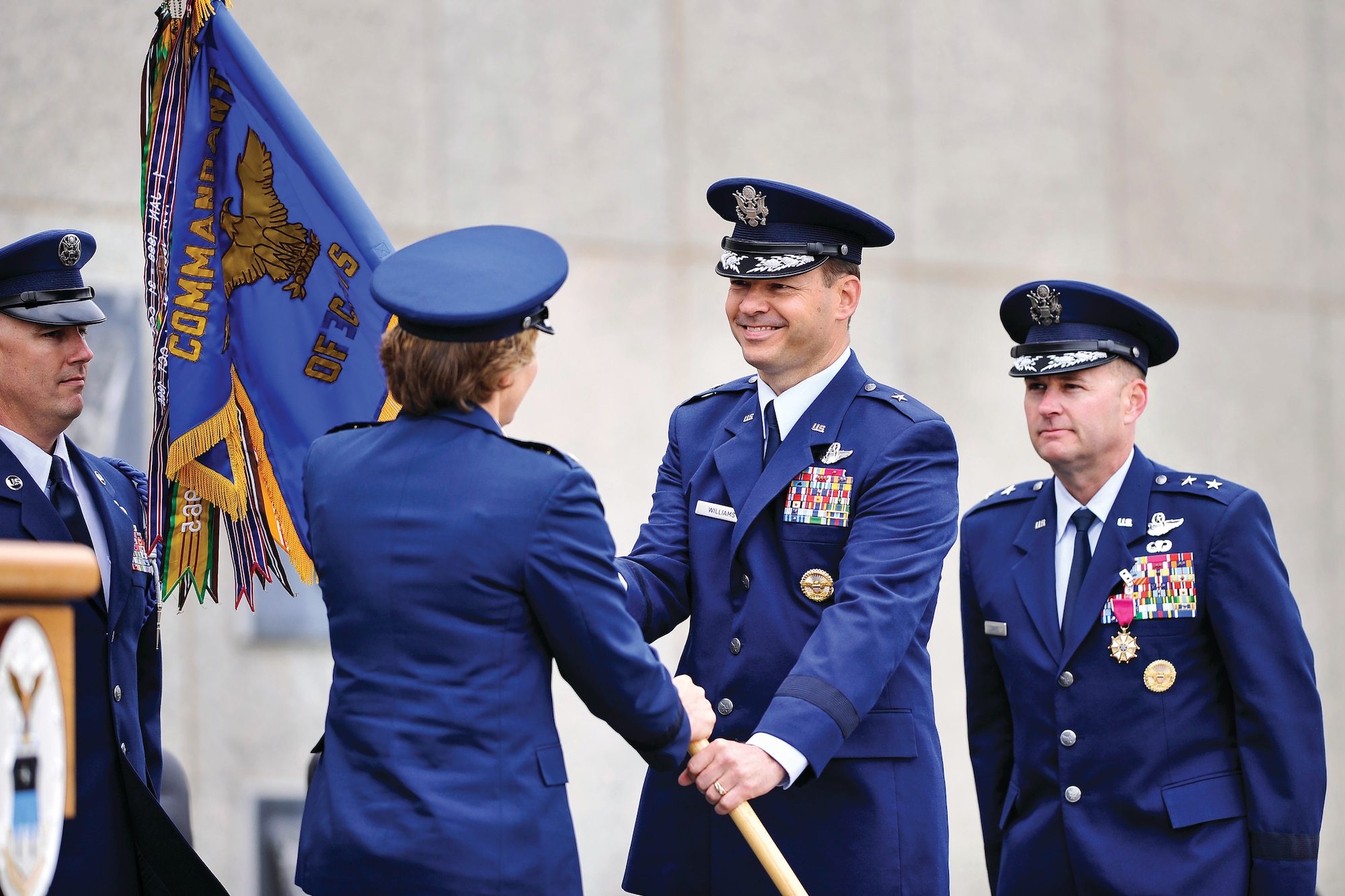 Brig. Gen. Stephen Williams takes the cadet wing guidon from Academy Superintendent Lt. Gen. Michelle D. Johnson July 1, symbolizing his acceptance of responsibilities as the Academy's new commandant of cadets. Williams replaces Maj. Gen. Gregory Lengyel (right). U.S. Air Force photo/Mike Kaplan)