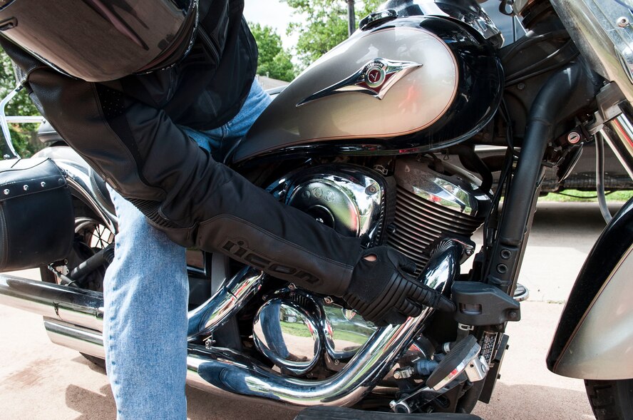 U.S. Air Force Staff Sgt. Saul Arvizu, 7th Civil Engineer Squadron, checks the tire pressure on his motorcycle June 18, 2014, in Abilene, Texas. Motorcycle safety is a major focus during the critical days of summer. Before riding, riders should check their tires and wheels, controls, lights, oil and fluids, chassis and stand. (U.S. Air Force photo by Airman 1st Class Kylsee Wisseman/Released) 