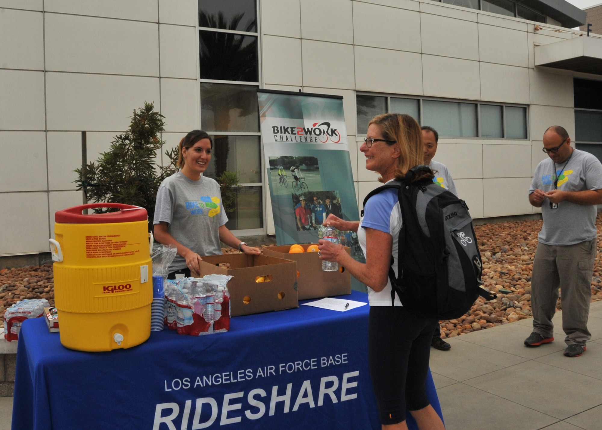 Mary Ellen Vojtek, an Aerospace Corporation employee, receives her reward for participating in the 2013 Bike to Work Day on May 22nd, 2013, sponsored by the 61st Civil Engineer and Logistics Squadron from Los Angeles Air Force Base in El Segundo, Calif. Bike to Work Day is an annual event held on various days in the Spring across the United States and Canada that promotes the bicycle as an option for commuting to work (U.S. Air Force photo by Sarah Corrice.)