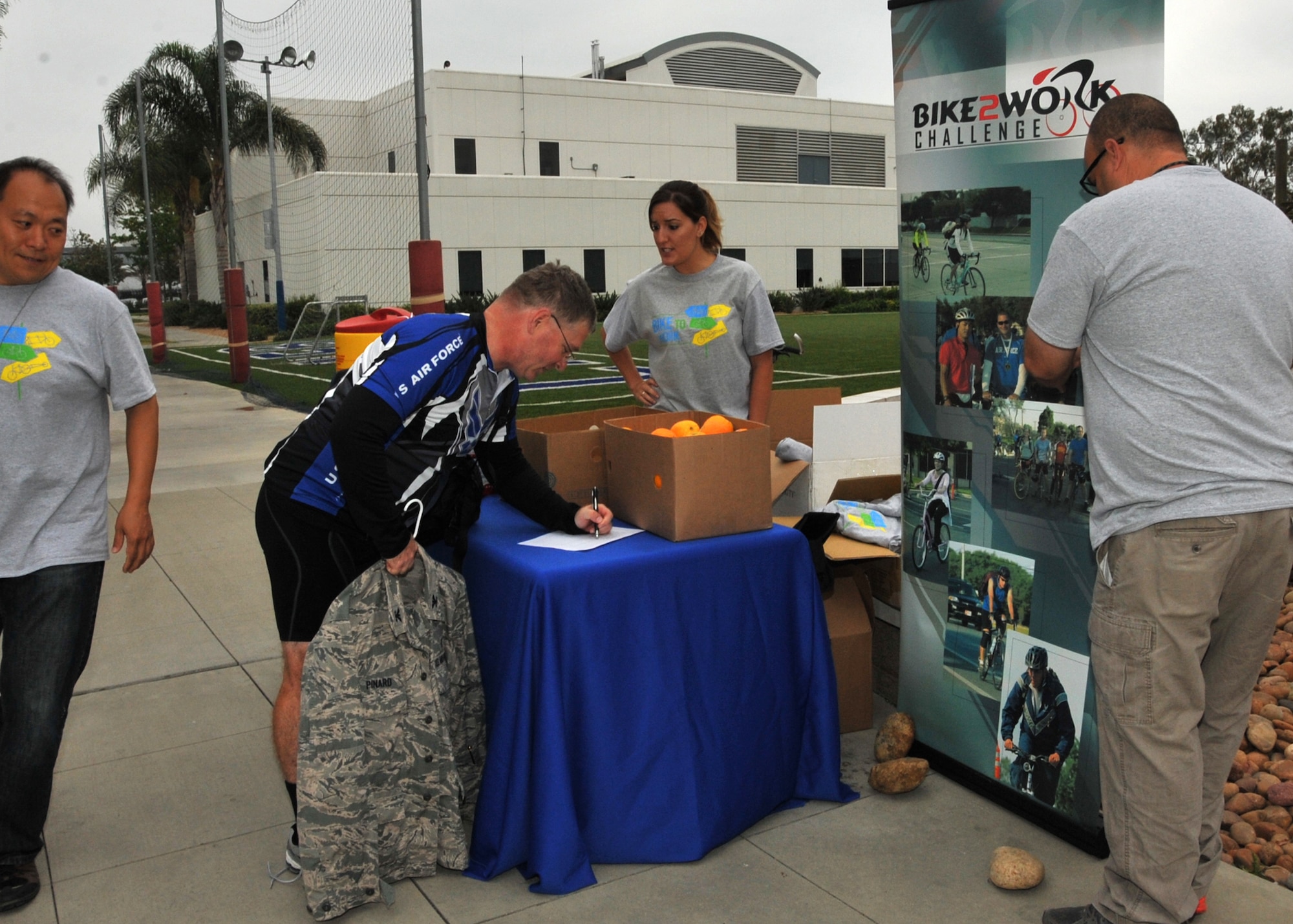 U.S. Air Force Colonel Russell Pinard, commander of the 61st Medical Squadron from Los Angeles Air Force Base signs the participation list on Bike to Work Day in El Segundo, Calif., on June 24, 2014. Bike to Work Day is an annual event held on various days in the Spring across the United States and Canada that promotes the bicycle as an option for commuting to work (U.S. Air Force photo by Sarah Corrice.)