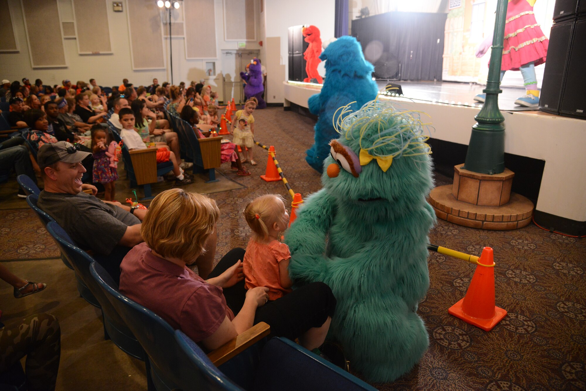 PETERSON AIR FORCE BASE, Colo. – Muppet Rosita says hello to Brianna Moser during the Sesame Street USO experience for military families at the base auditorium June 28. The show is about Katie, a military child and Muppet, who is moving from Sesame Street to a new base. Through song and dance, the rest of the Muppets show her that moving is not so bad. (U.S. Air Force photo/Tech. Sgt. Jared Marquis)