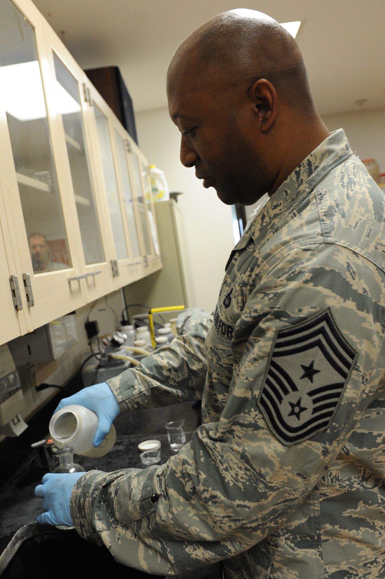 Chief Master Sgt. Wesley Mathias, 375th Air Mobility Wing command chief, tests a sample of water at the waste water treatment plant to ensure that it is safe to use at Scott Air Force Base, Ill. on June 23, 2014. The plant cleans and treats waste water and the base reuses it to irrigate the golf course and other base locations. (U.S. Air Force photo by Senior Airman Sarah Hall-Kirchner/Released)