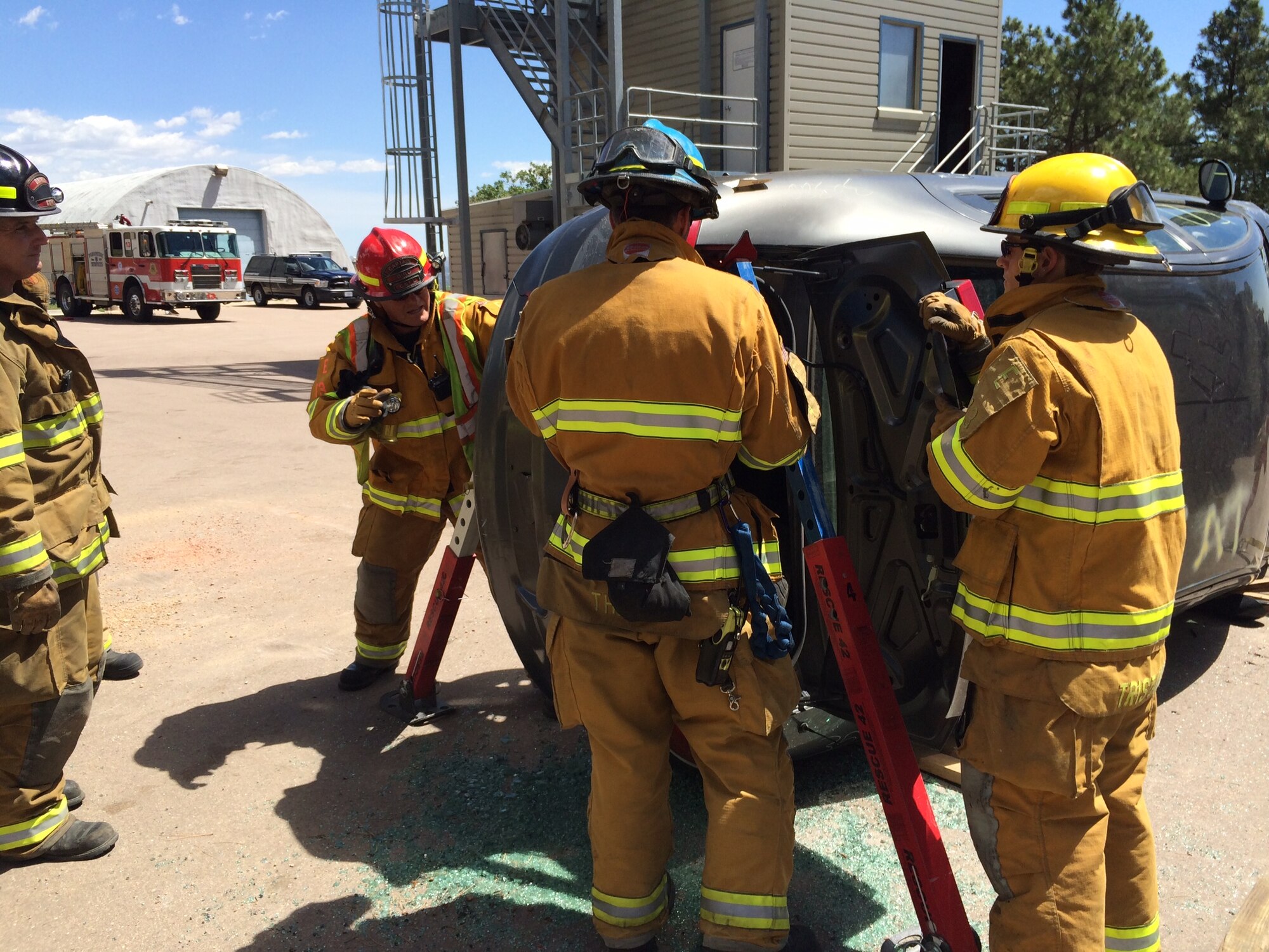 CHEYENNE MOUNTAIN AIR FORCE STATION, Colo. – Firefighters from Cheyenne Mountain Fire and Emergency Services and the Colorado Springs Fire Department stabilize a vehicle during joint auto extrication training. The training provided operational familiarization in the event the two agencies need to work together during an accident response. The training was held June 30 at Cheyenne Mountain Air Force Station. (U.S. Air Force photo) 