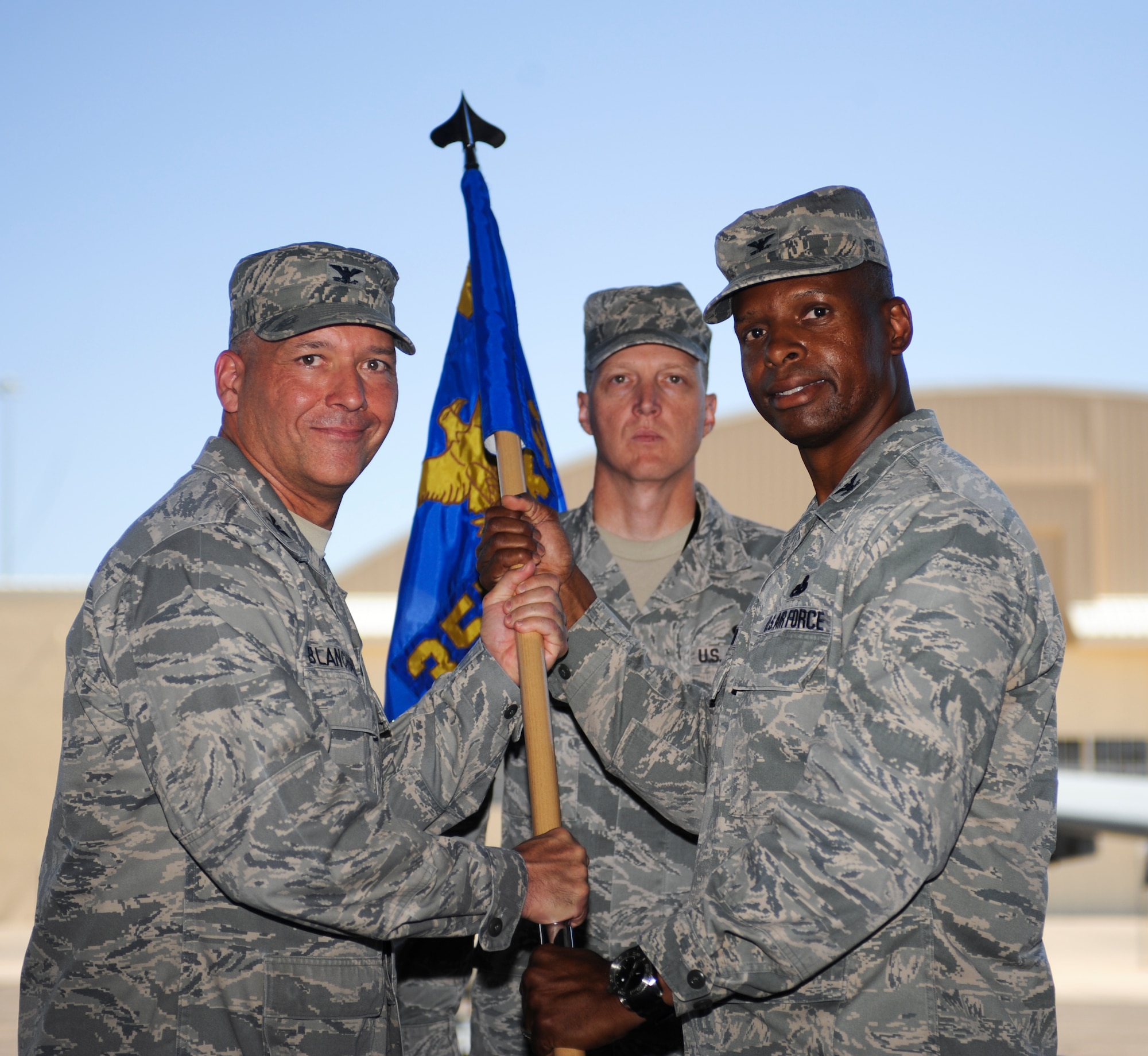 U.S. Air Force Col. Kevin Blanchard, 355th Fighter Wing commander, hands off responsibility of the 355th Maintenance Group to Col. Kevin Howard, newly appointed commander of the 355th MXG, during a Change of Command Ceremony at Davis-Monthan Air Force Base, Ariz., July 1, 2014. A change of command is a military tradition that represents a formal transfer of authority and responsibility for a unit from one commanding or flag officer to another. (U.S. Air Force photo by Airman 1st Class Sivan Veazie/Released)