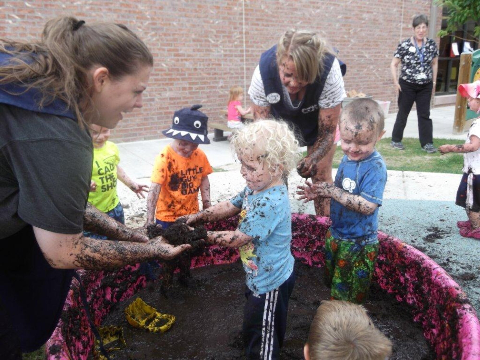 PETERSON AIR FORCE BASE, Colo. – Children at the Peterson Child Development Centers got a little dirty June 27 using brushes, paper on easels, cups and play dishes to paint and make mud pies. As part of International Mud Day celebration, children were encouraged to be creative and enjoy the fun of just playing in mud. “Many of us played with simple tools such as mud, sticks and rocks when we were younger and we tend to forget what a creative, sensory and fun activity it can be,” said Karen Morgan, 21st Force Support Squadron Child Development Center. (U.S. Air Force photo)