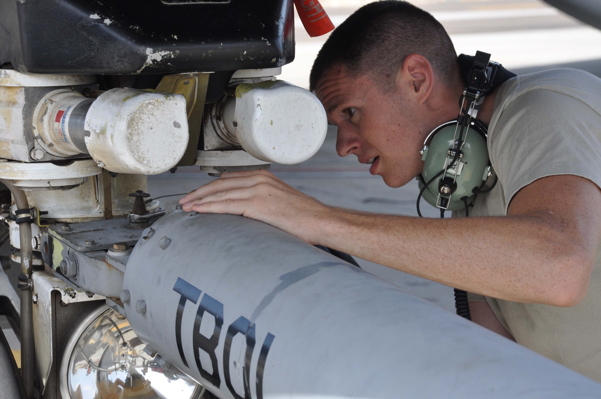 SrA Vinnie Melchiorri secures a tow bar to the front landing gear of a KC-135 during a humanitarian mission to Paraguay. The mission was made possible by the Denton Amendment, a jointly administered program allowing U.S. citizens and organizations to use space available on U.S. military planes to deliver goods to countries in need. (U.S. Air Force photo by Capt Joe Simms)