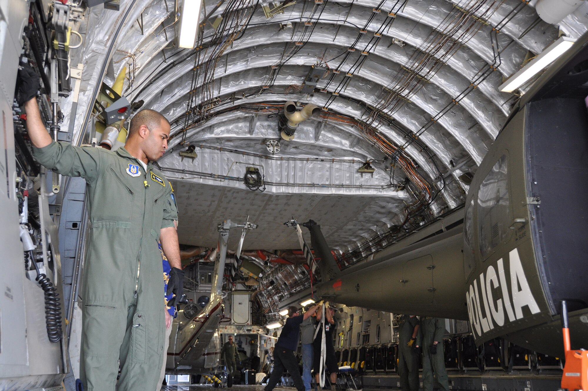 Tech. Sgt. Joe Poltor, a loadmaster with the 317th Airlift Squadron, Joing Base Charleston S.C. loads a helicopter onboard a C-17 Globemaster III.  (U.S. Air Force photo by Staff Sgt. Bobby Pilch)