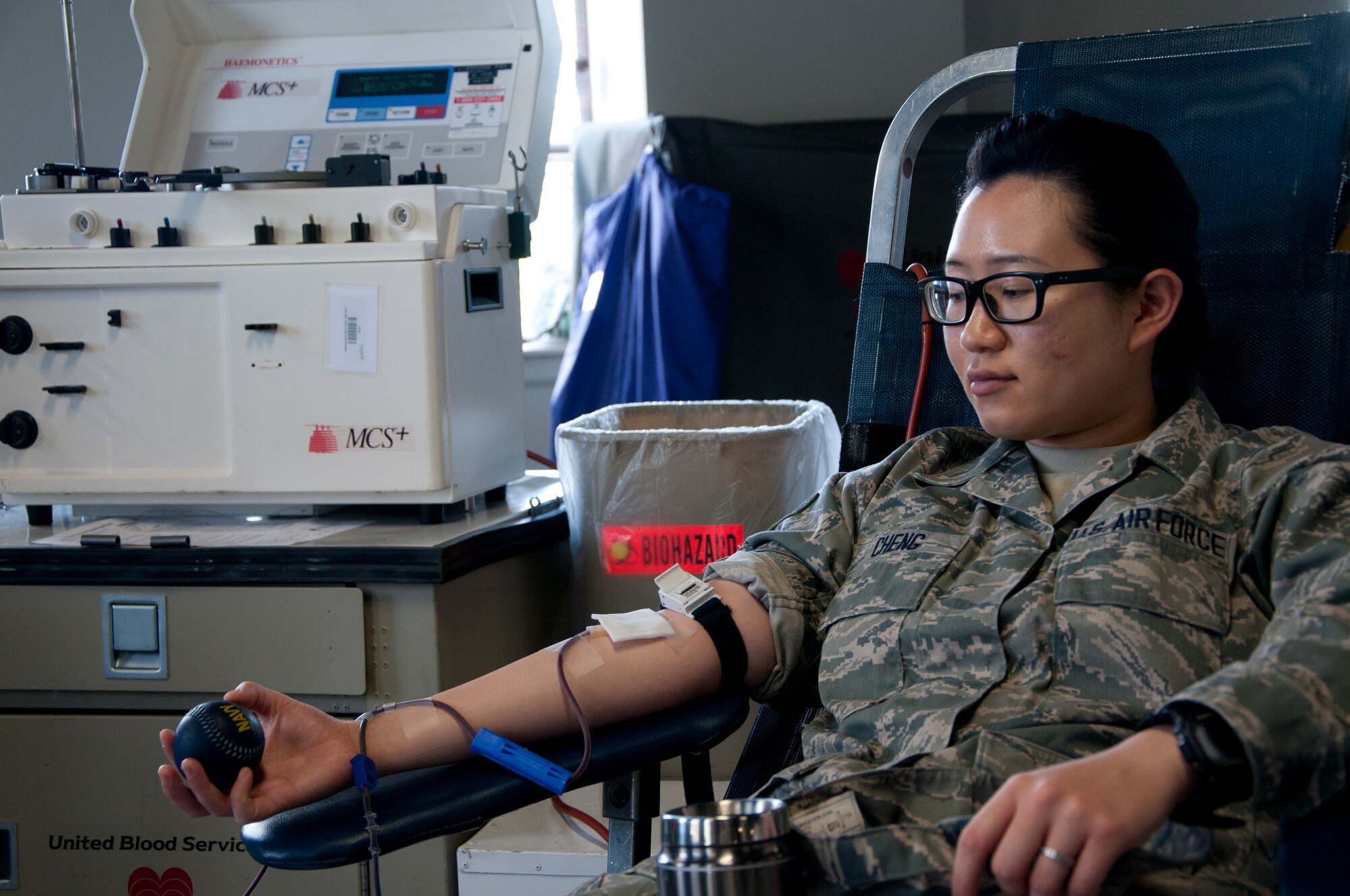 Airman 1st Class Natalie Cheng, 90th Medical Operations Squadron physical therapy technician, donates blood during a United Blood Services drive on F.E. Warren Air Force Base, Wyo., June 24, 2014. For more information on how to donate, visit http://www.bloodhero.com/ or call 638-3326. Another blood drive on F.E. Warren is scheduled for August 1, 2014.  (U.S. Air Force photo by Airman 1st Class Jason Wiese)