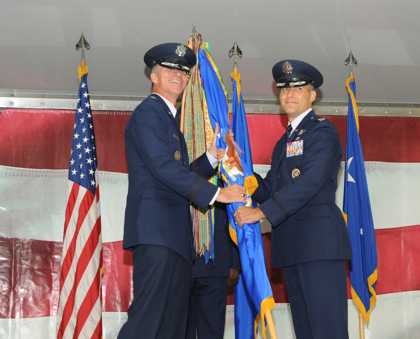 Col. Matthew C. Isler (right) accepts the 12 FTW guidon from Maj. Gen. Michael A. Keltz, Director of Intelligence, Operations and Nuclear integration Headquarters, Air Education and Training Command, Joint Base San Antonio-Randolph, Texas, during the Change of Command Ceremony June 25.  These ceremonies represent the formal passing of responsiblity, authority and accountablility of command from one officer to another. (U.S. Air Force photo by Melissa Peterson.