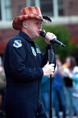 Senior Master Sgt. Ryan Carson, NCO in-charge and vocalist for the U.S. Air Force band Max Impact, dons a cowboy hat while singing June 27 in the Cheyenne Depot. Carson and the other members of the band performed a free concert during one of the Wyoming Tribune Eagle’s Fridays on the Plaza events. (U.S. Air Force photo by Airman 1st Class Brandon Valle)