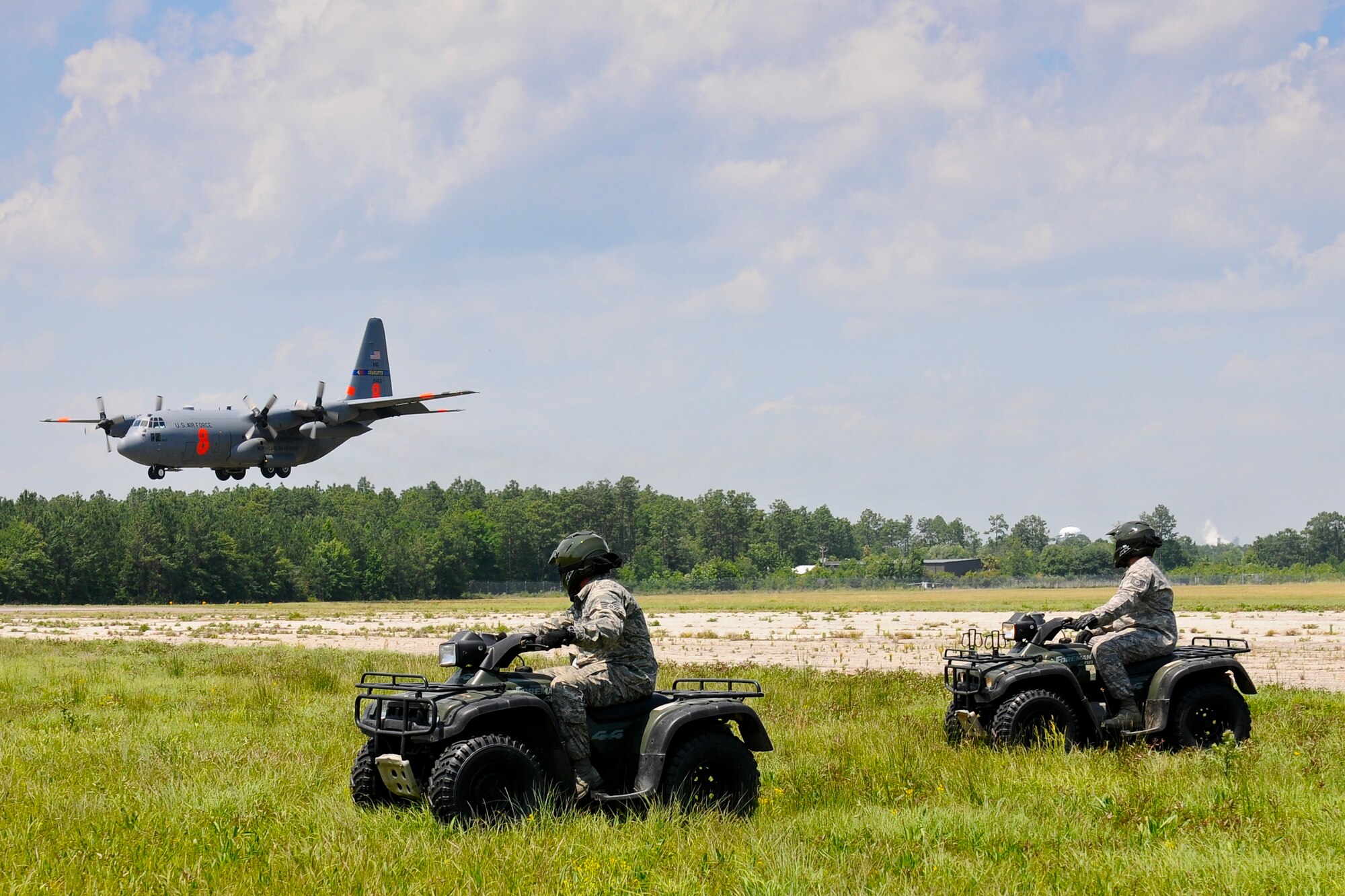 U.S. Air Force Tech. Sgt. Eric Peter and Staff Sgt. Chad Peebles, assigned to the 169th Security Forces Squadron, South Carolina Air National Guard, conduct perimeter checks with ATV’s while a C-130 Hercules cargo plane, assigned to the 145th Airlift Wing, lands at the Georgetown County Airport, S.C., June 5, 2014.  South Carolina National Guard Soldiers and Airmen are working side-by-side with the S.C. Emergency Management Division and first responders from local emergency agencies, to effectively respond to any hurricane that may threaten the state. The exercise is based on a hurricane post-landfall response between federal, state and local agencies, which includes training in communications, first responder skills, with the focus on how to better protect and assist citizens during emergency situations.  (U.S. Air National Guard photo by Tech. Sgt. Jorge Intriago/Released)
