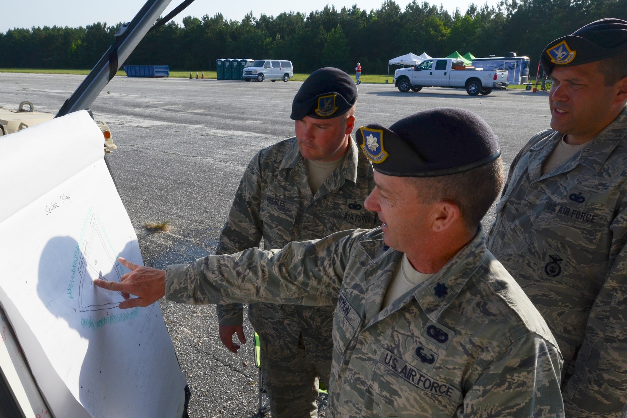 U.S. Air Force Lt. Col. Paul Laymon, center, the 169th Security Forces Squadron commander, South Carolina Air National Guard, explains where to conduct perimeter checks at the Georgetown County Airport, S.C., to Staff Sgt. Chad Peebles and Tech. Sgt. Eric Peter, June 5, 2014.  Laymon is in charge of keeping security around the airfield during a hurricane preparedness exercise. South Carolina National Guard Soldiers and Airmen are working side-by-side with the S.C. Emergency Management Division and first responders from local emergency agencies, to effectively respond to any hurricane that may threaten the state. The exercise is based on a hurricane post-landfall response between federal, state and local agencies, which includes training in communications, first responder skills, with the focus on how to better protect and assist citizens during emergency situations.  (U.S. Air National Guard photo by Tech. Sgt. Jorge Intriago/Released)
