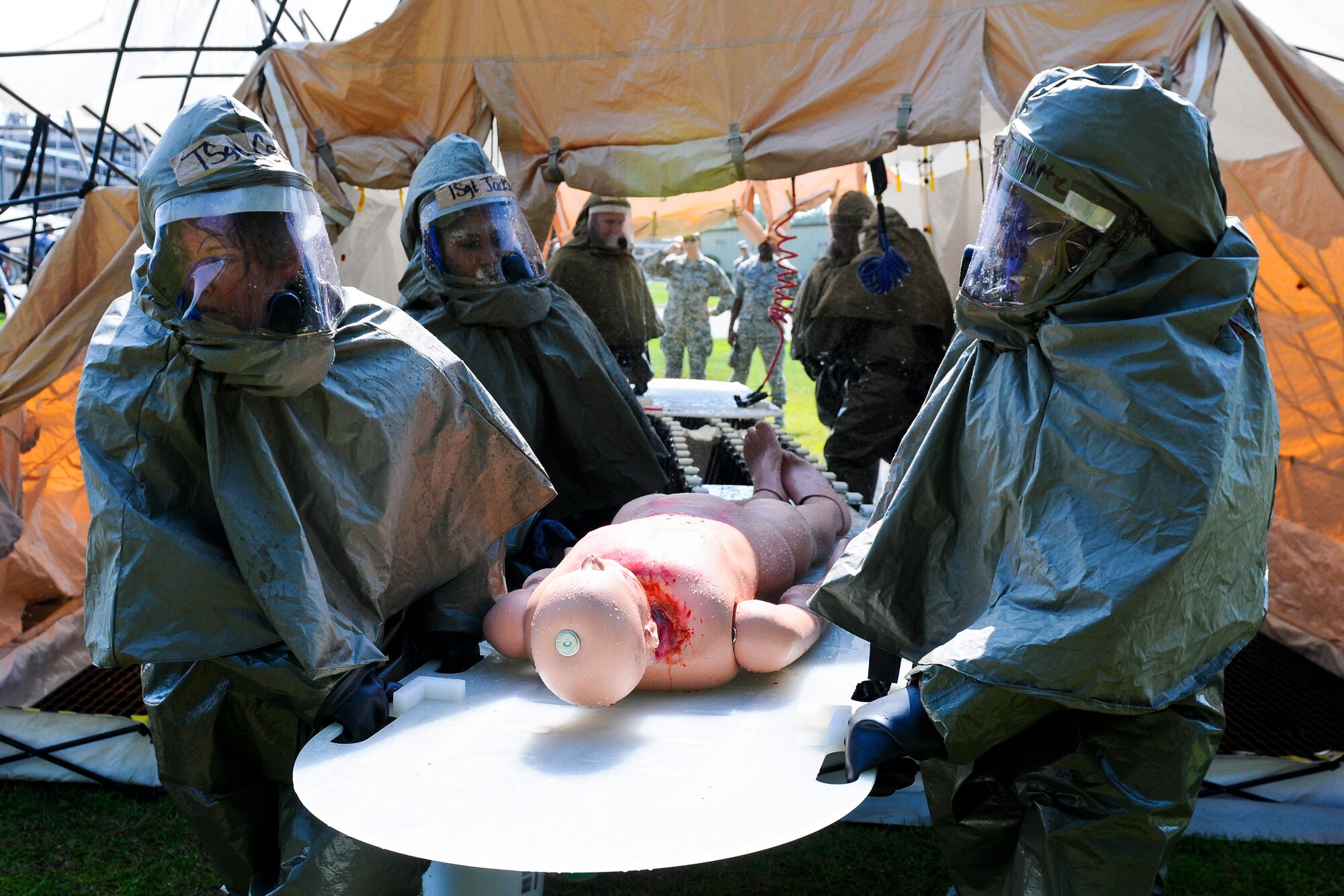 U.S. Air Force patient decontamination team members, assigned to the 169th Fighter Wing, South Carolina Air National Guard, carry a mannequin used to simulate a victim during a chemical spill scenario at a local company in Georgetown, S.C., June 5, 2014.  South Carolina National Guard Soldiers and Airmen are working side-by-side with the S.C. Emergency Management Division and first responders from local emergency agencies, to effectively respond to any hurricane that may threaten the state. The exercise is based on a hurricane post-landfall response between federal, state and local agencies, which includes training in communications, first responder skills, with the focus on how to better protect and assist citizens during emergency situations.  (U.S. Air National Guard photo by Tech. Sgt. Jorge Intriago/Released)
