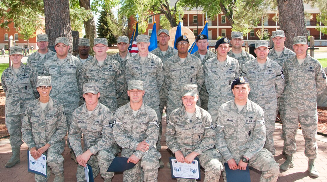 F.E. Warren Airmen who promoted in rank in June or who were scheduled to “sew on” June 1, pose for a photo with Col. Tracey Hayes, 90th Missile Wing commander, and Chief Master Sgt. Samuel Couch, 90th MW command chief, in Prado Park, the courtyard between the F.E. Warren Base Theater and the Fall Hall Community Center June 30. (U.S. Air Force photo by Airman 1st Class Jason Wiese)