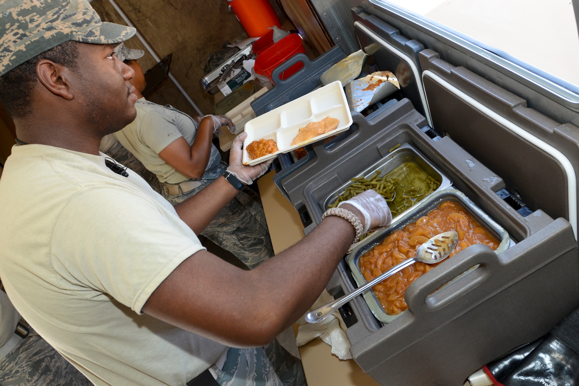 U.S. Air Force Staff Sgt. Quinten Quinones, assigned to the 169th Force Support Squadron’s Services Flight, serves Unit Ground Rations to South Carolina Air National Guard Airmen at the Georgetown County Airport, S.C., June 4, 2014. Quinones is part of deployable team, which prepares and serves hot meals from a Single Pallet Expeditionary Kitchen. His unit is supporting a hurricane preparedness exercise as part of the Airmen who are working side-by-side with the S.C. Emergency Management Division and first responders from local emergency agencies, to effectively respond to any hurricane that may threaten the state. The exercise is based on a hurricane post-landfall response between federal, state and local agencies, which includes training in communications, first responder skills, with the focus on how to better protect and assist citizens during emergency situations.  (U.S. Air National Guard photo by Tech. Sgt. Jorge Intriago/Released)
