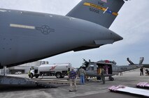Airmen from the 317th Airlift Squadron, Joint Base Charleston, S.C. load a helicopter into the cargo bay of a C-17 Globemaster III. (U.S. Air Force photo by Staff Sgt. Bobby Pilch)
