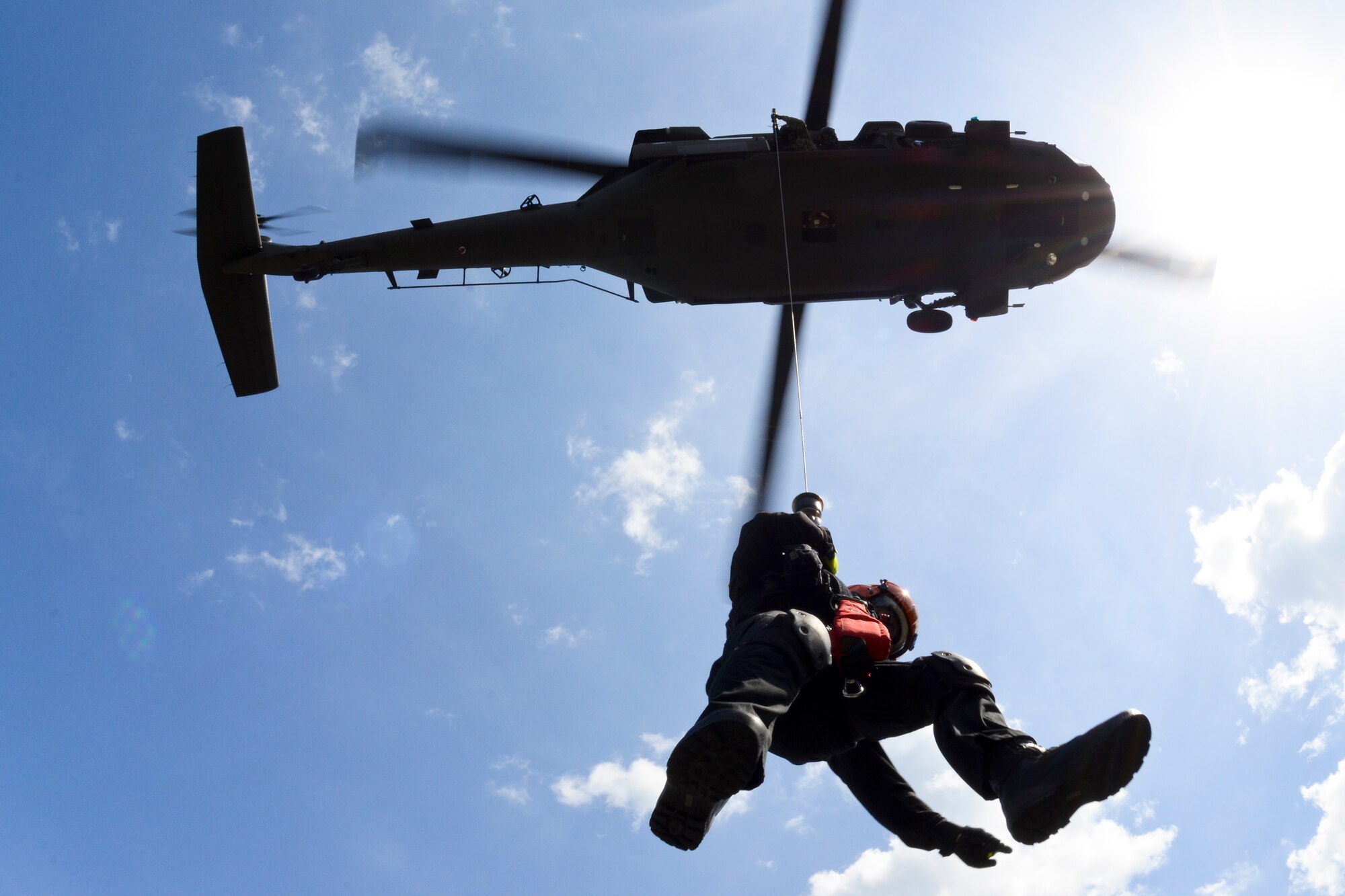 A South Carolina Helicopter Aquatic Rescue Team (SC-HART) member is lowered from a S.C. National Guard UH-60 Blackhawk helicopter to the Midway Fire Rescue tower at Pawleys Island, S.C., June 3, 2014. South Carolina National Guard Soldiers and Airmen are working side-by-side with the S.C. Emergency Management Division and first responders from local emergency agencies, to effectively respond to any hurricane that may threaten the state. The exercise is based on a hurricane post-landfall response between federal, state and local agencies, which includes training in communications, first responder skills, with the focus on how to better protect and assist citizens during emergency situations.  (U.S. Air National Guard photo by Tech. Sgt. Jorge Intriago/Released)
