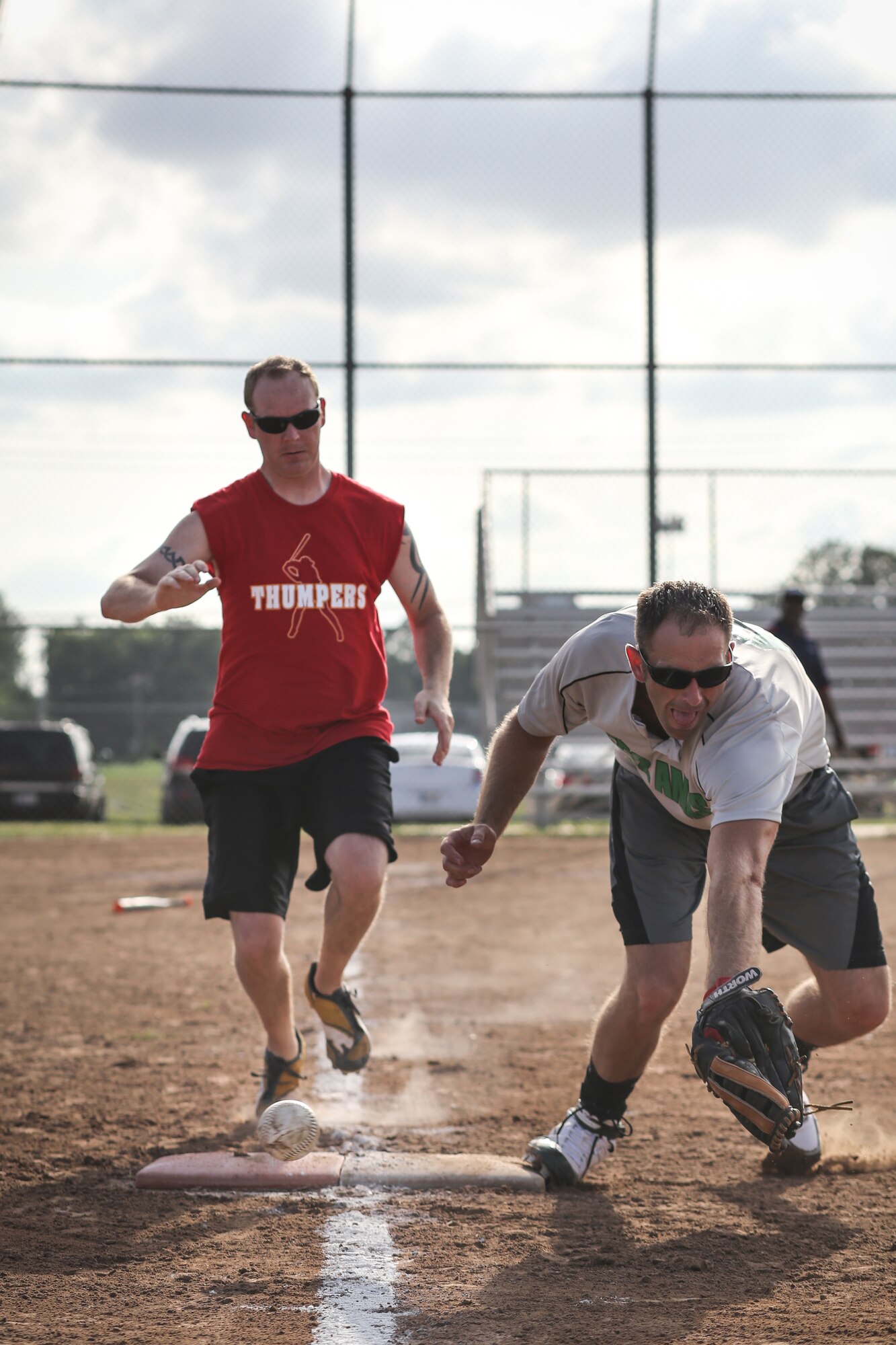 Tech. Sgt. TJ Milliken from the 970th Airborne Air Control Squadron races to first base while an Eagles player reaches too late for the ball on June 26 at Tinker Air Force Base, Oklahoma. The Tinker softball league kicked off a week late due to weather on opening night a week before. (U.S. Air Force Photo/Staff Sgt. Caleb Wanzer)