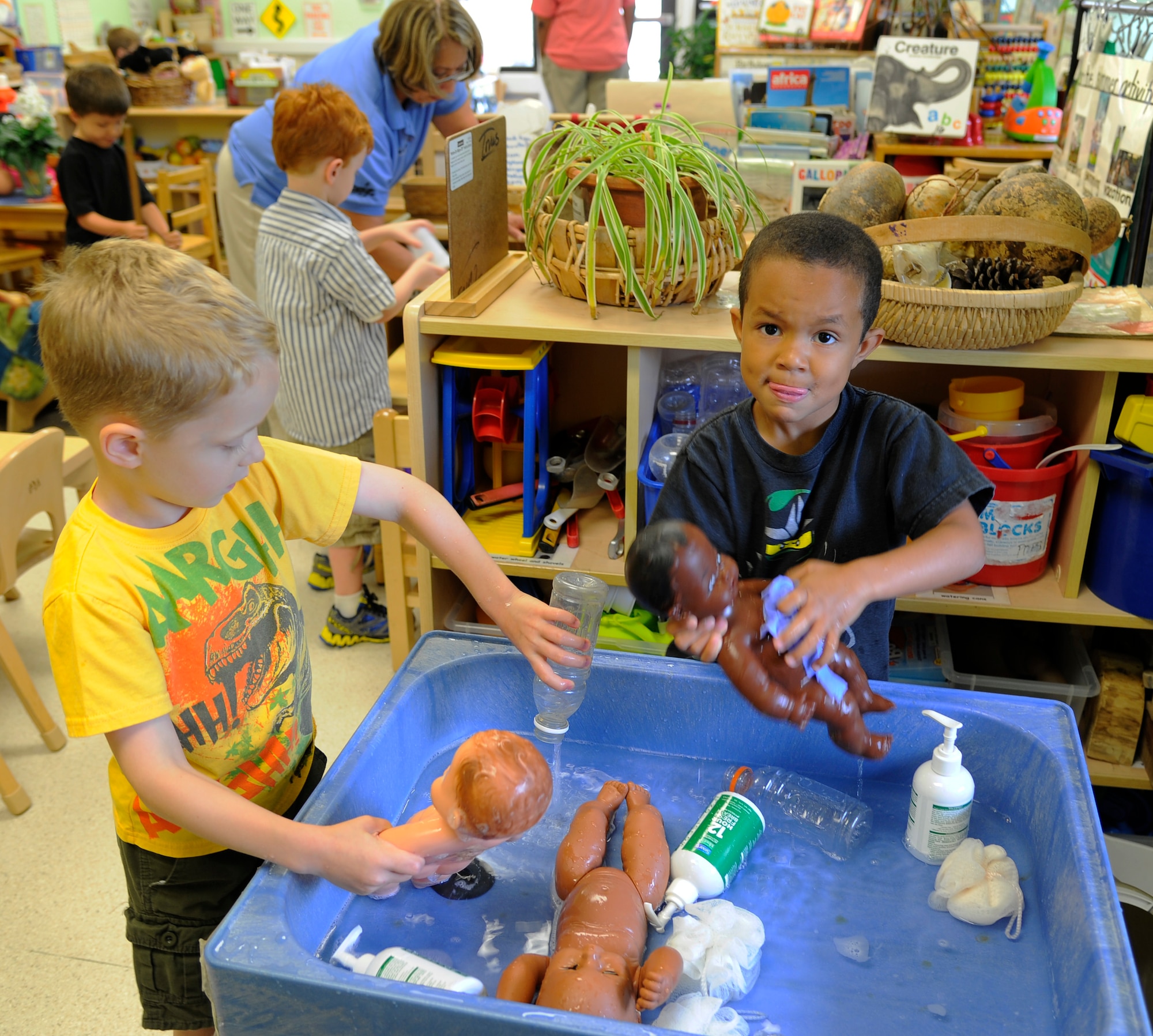 Children wash dolls during a class at the main child development center on Hurlburt Field, Fla., June 25, 2014. The children went through different learning stations, this one taught hygiene. (U.S. Air Force photo/Staff Sgt. Sarah Hanson)