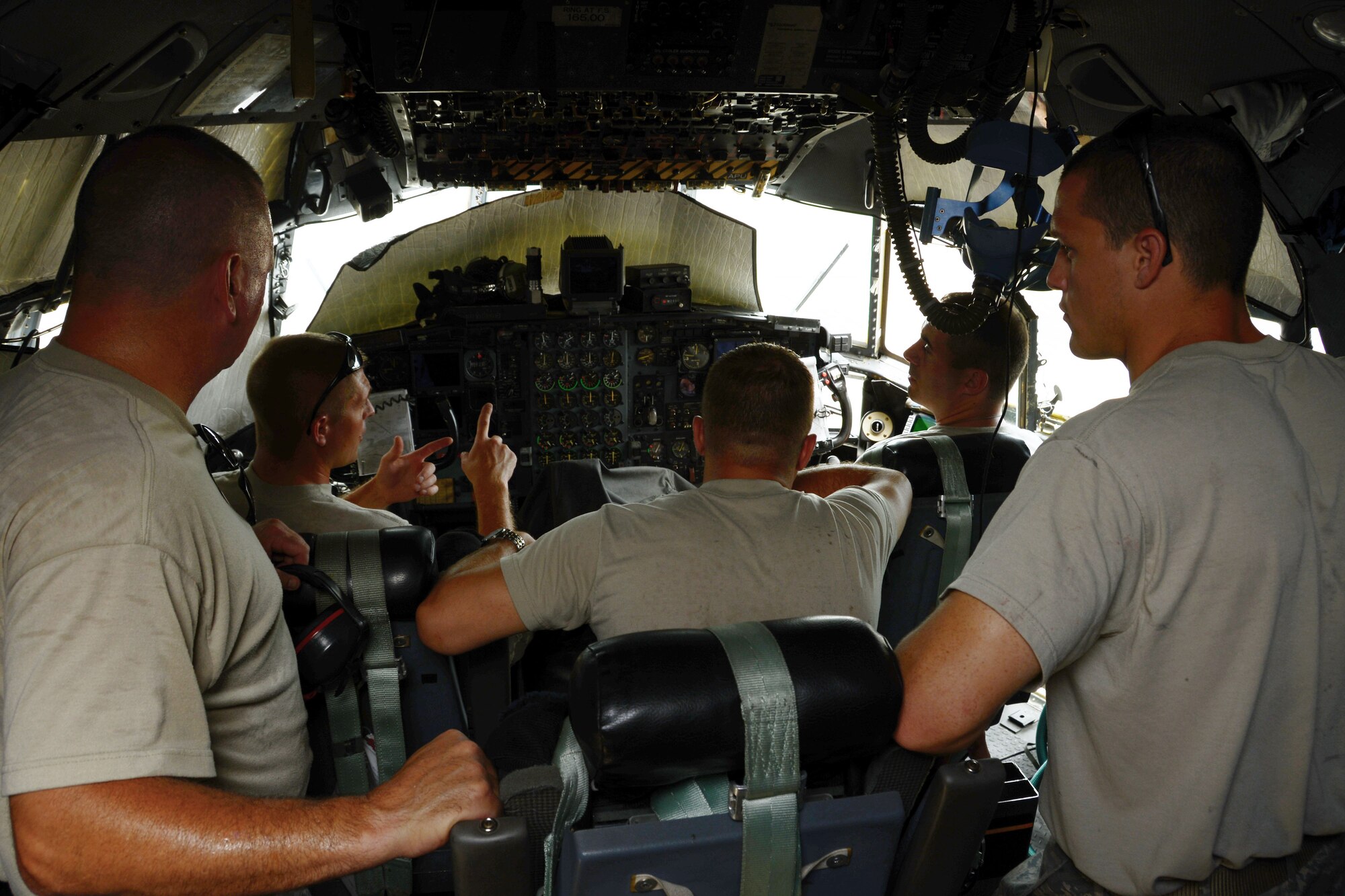 Airmen from both the 103rd Maintenance Squadron and 123rd Maintenance Group go over the auxiliary power unit checklist in the cockpit of the C-130H aircraft at the Combat Readiness Training Center, Gulfport, Miss., June 25, 2014. (U.S. Air National Guard photo by Senior Airman Jennifer Pierce)