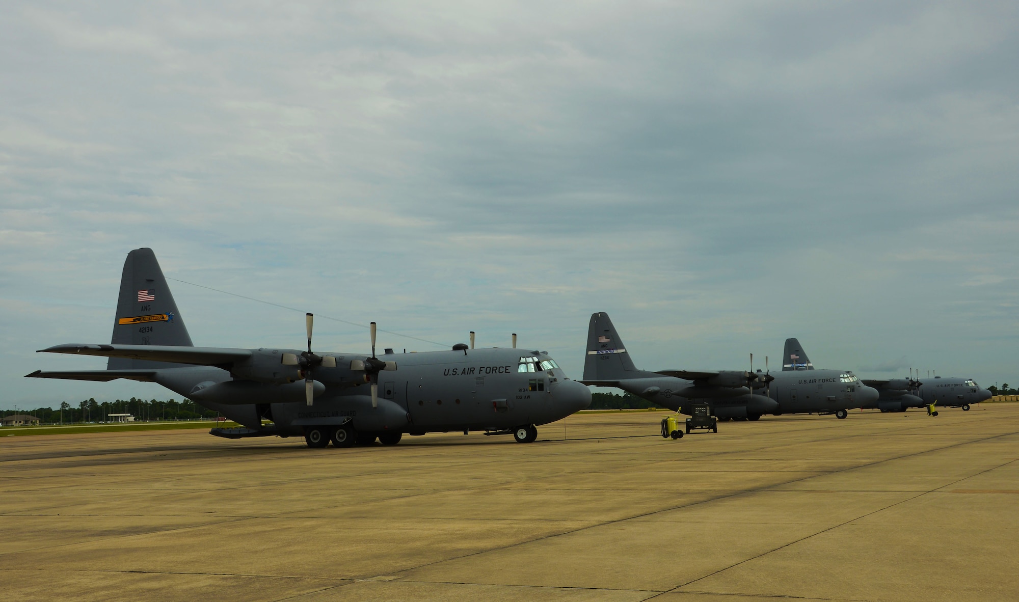 A C-130H aircraft, assigned to the 103rd Airlift Wing, is positioned next to C-130 aircraft from the Kentucky Air National Guard and will serve as a training tool for aircraft maintainers from both the 103rd Maintenance Squadron and the 123rd Maintenance Group while deployed to the Combat Readiness Training Center, Gulfport, Miss., June 25, 2014. (U.S. Air National Guard photo by Senior Airman Jennifer Pierce)