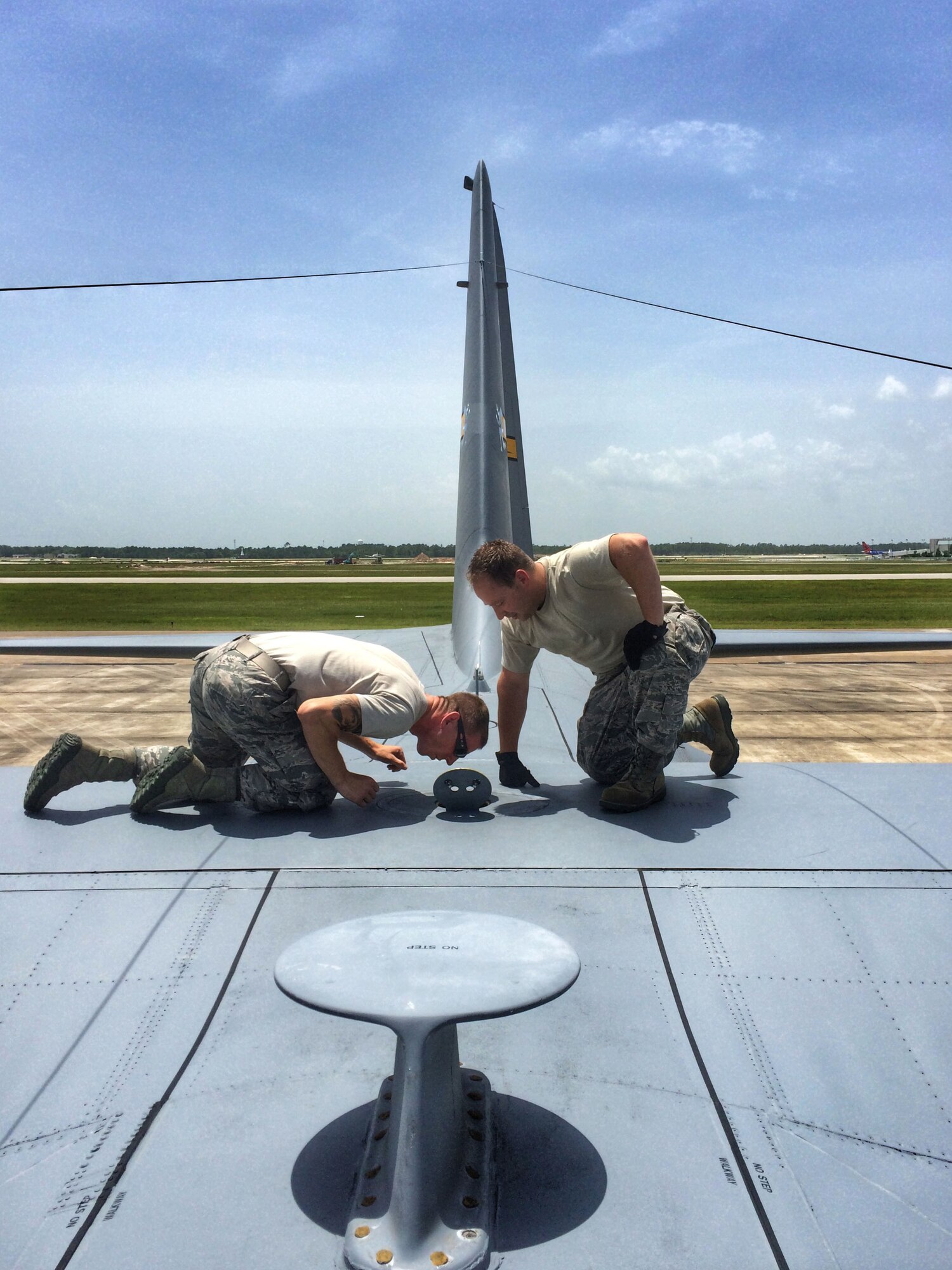 Senior Airman Kyle Murkowicz (left) and Tech. Sgt. Paul Rozum, both with the 103rd Airlift Wing Maintenance Squadron, inspect a center dry bay as part of a basic post flight inspection on a C-130H Hercules at the Combat Readiness Training Center, Gulfport, Miss., June 24, 2014. Members of the 103rd maintenance squadron are receiving training for the C-130H in Gulfport. (U.S. Air National Guard photo by Senior Airman Jennifer Pierce)