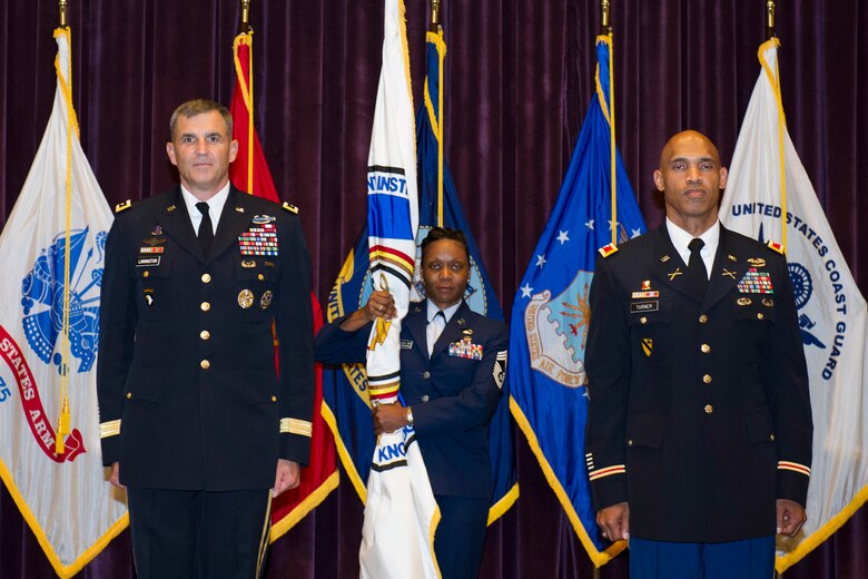 Lt. Gen. Michael Linnington, Military Deputy to the Under Secretary of Defense for Personnel and Readiness, left, and Army Col. Reese Turner, stand at attention during the Defense Equal Opportunity Management Institute assumption of command ceremony June 27, 2014, at Patrick Air Force Base, Fla. (U.S. Air Force photo/Matthew Jurgens) 