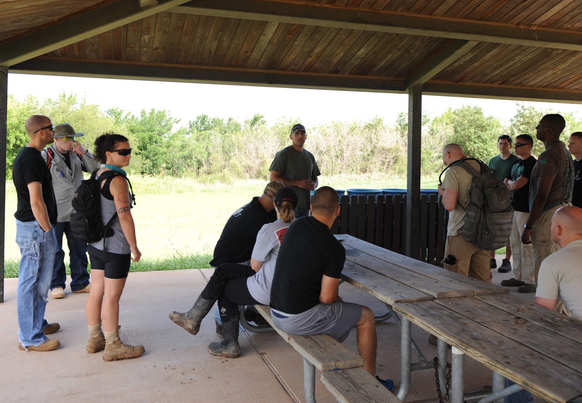 U.S. Air Force Tech. Sgt. Judah Davis, center, briefs Dyess Air Force Base Airmen and family members June 14, 2014, at Kirby Lake in Abilene, Texas. Davis organized a lake clean up, where he and more than 30 volunteers spent part of their weekend removing garbage left at the lake. (U.S. Air Force photo by Airman 1st Class Alexander Guerrero/Released)