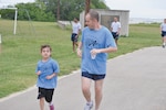 Staff Sgt. Russell Southard and his daughter Annabelle, 6, run toward the finish line at the Lesbian, Gay, Bisexual, and Transgender Pride Month Observance-Run Toward Diversity 5K June 27 at the Gillum Fitness Center. Annabelle earned first place honors in the Females 30 and under category (Photos by Jose T. Garza III)