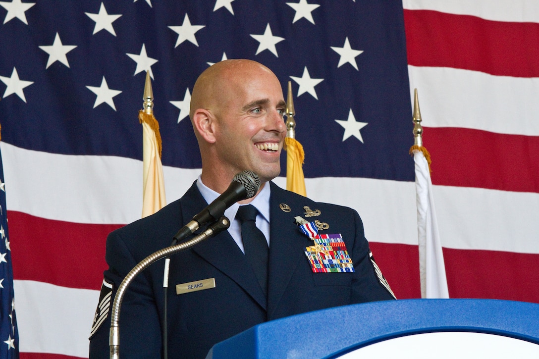 Silver Star recipient Master Sgt. Michael F. Sears, 177th Fighter Wing, addresses National Guard Bureau and New Jersey National Guard leadership, family, friends and fellow 177th Airmen June 28, 2014, at the 177th Fighter Wing in Egg Harbor Township, N.J. He received the Silver Star, the third highest military award, for actions while deployed to Afghanistan on Sept. 29, 2012. On that day, a three-man Air Force explosive ordnance disposal team led by Sears found itself in the middle of a complex ambush in Ghazni province, Afghanistan. During the course of a two-hour firefight, Sears provided life-saving aid to a fallen coalition soldier from Poland, ran five times through a 150-yard open area riddled with enemy machine gun fire to direct his team in returning fire, and continued on with the fight after being knocked temporarily unconscious by a rocket-propelled grenade blast. Sears joins a group of 58 Airmen who have been awarded the Silver Star since the Global War on Terrorism began. (U.S. Air National Guard photo by Master Sgt. Mark C. Olsen/Released)