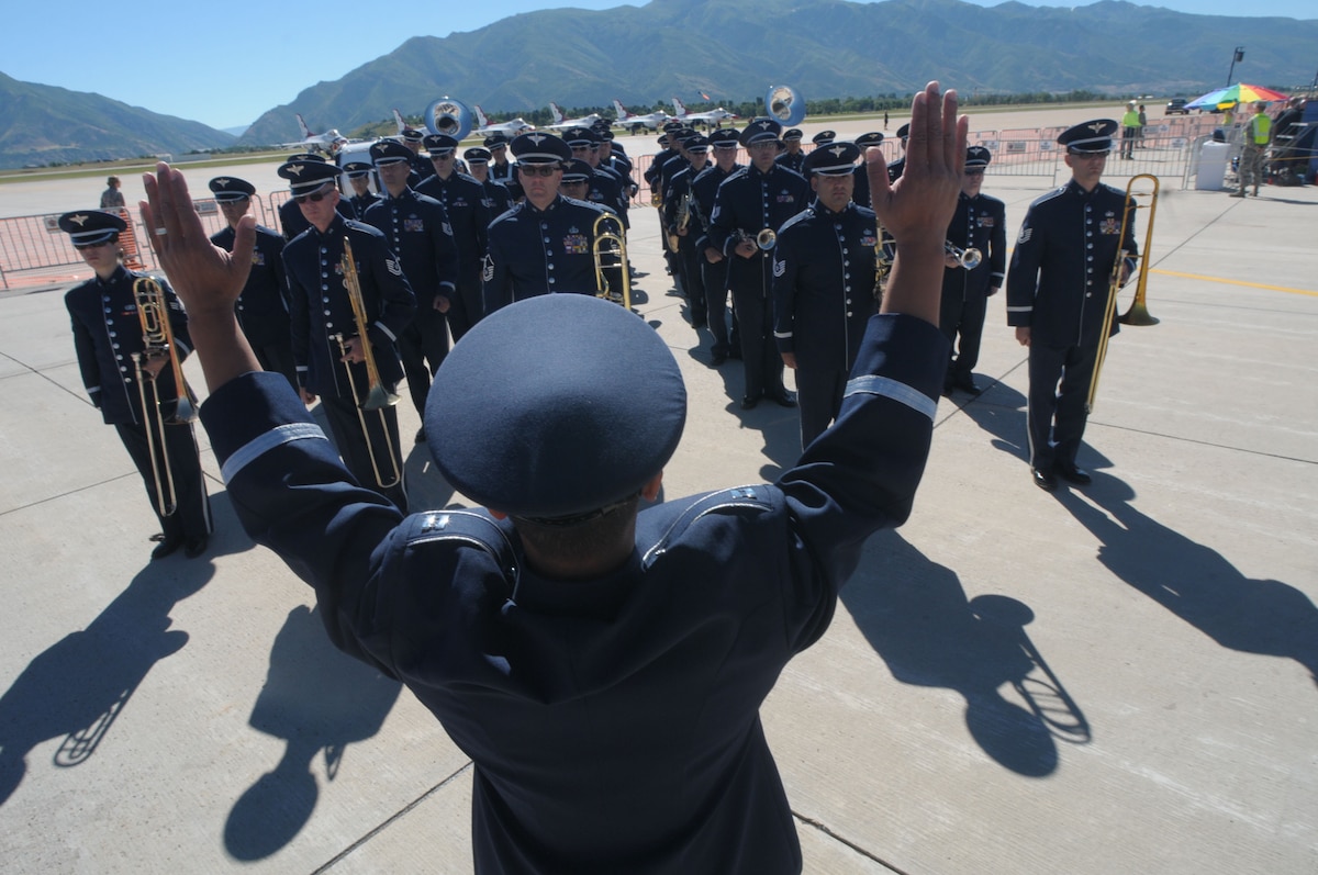 U.S. Air Force Capt. Vu Nguyen, commander of the 562nd Air Force Band of the West Coast prepares the band to perform the National Anthem at Hill Air Force Base in Layton, Utah on June 29, 2014. (U.S. Air National Guard photo by Airman 1st Class Madeleine Richards/Released)