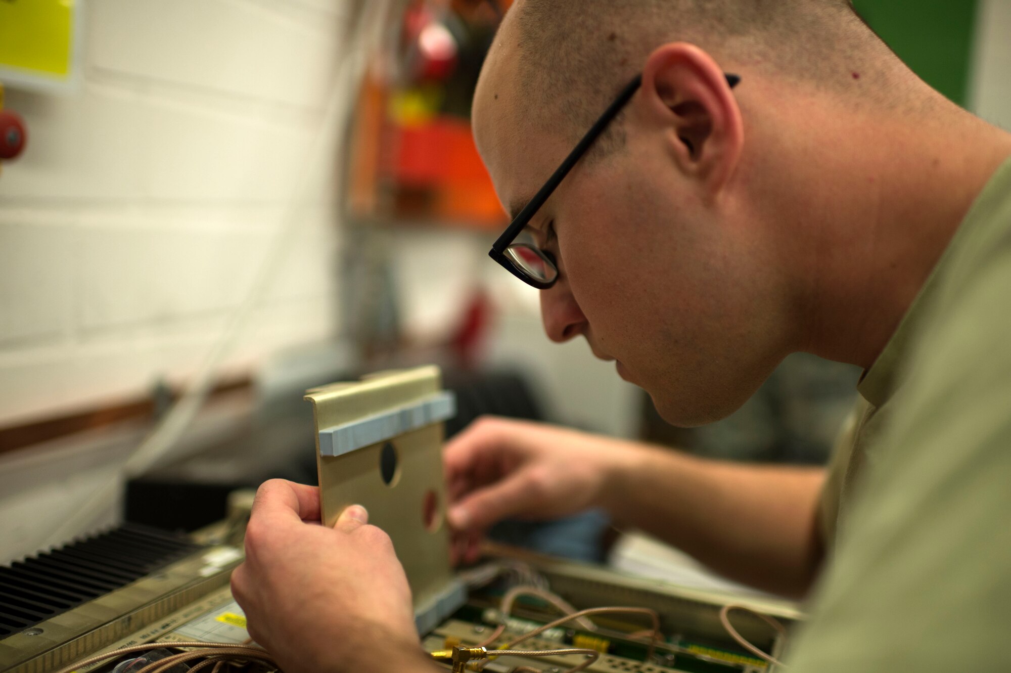 U.S. Air Force Senior Airman Alex Lollar, 606th Air Control Squadron radio frequency transmission technician from Pensacola, Fla., assembles a GRC-171 radio transceiver at Spangdahlem Air Base, Germany, June 30, 2014. In working condition, the transceiver, designed for reliable air traffic control communications, can transmit a signal to aircraft approximately 250 nautical miles away. (U.S. Air Force photo by Senior Airman Gustavo Castillo/Released)  